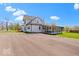 Charming two-story home with white siding and a sunroom on a large lot with a long driveway at 5420 Mcfarland Rd, Indianapolis, IN 46227