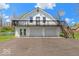 Charming two-story home featuring three-car garage, balcony, and a classic white facade at 5420 Mcfarland Rd, Indianapolis, IN 46227