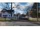 Charming white farmhouse with black shutters, set back from the road behind a white fence at 5420 Mcfarland Rd, Indianapolis, IN 46227
