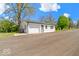 View of a one-car garage and long driveway at 5420 Mcfarland Rd, Indianapolis, IN 46227