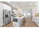 Modern kitchen featuring stainless steel appliances, island with seating, and a bright, open layout at 5420 Mcfarland Rd, Indianapolis, IN 46227