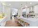 Spacious white kitchen with stainless steel appliances, pendant lighting, and an open design to the living area at 5420 Mcfarland Rd, Indianapolis, IN 46227