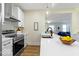 Modern kitchen featuring stainless steel appliances, white quartz countertops, and a stylish open layout at 5420 Mcfarland Rd, Indianapolis, IN 46227