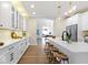 Open kitchen with stylish white cabinetry, quartz countertops, stainless steel appliances, and bar stool seating at 5420 Mcfarland Rd, Indianapolis, IN 46227