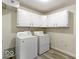 Functional laundry area equipped with washer, dryer, and upper cabinetry at 5420 Mcfarland Rd, Indianapolis, IN 46227