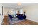 Cozy living room featuring a plush blue velvet sofa, eye-catching rug and sleek wood flooring at 5420 Mcfarland Rd, Indianapolis, IN 46227