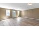 Bright living room with neutral walls, modern vinyl flooring, and natural light at 5420 Mcfarland Rd, Indianapolis, IN 46227