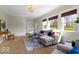 Comfortable living room with a sectional couch, hardwood floors, and an abundance of natural light at 5420 Mcfarland Rd, Indianapolis, IN 46227