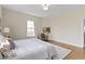 Bedroom showcasing a large window and a bed covered with white linens at 5420 Mcfarland Rd, Indianapolis, IN 46227
