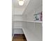 Pantry featuring built-in shelving and hardwood floors at 5420 Mcfarland Rd, Indianapolis, IN 46227