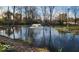 Water fountain in a pond surrounded by trees and green landscape at 5420 Mcfarland Rd, Indianapolis, IN 46227