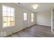 Bright room featuring updated flooring, large windows, and neutral wall colors at 5420 Mcfarland Rd, Indianapolis, IN 46227
