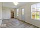 Bright room with vinyl floors, ample natural light, and neutral walls at 5420 Mcfarland Rd, Indianapolis, IN 46227