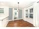 Bright dining area featuring hardwood floors, large windows, and a view of the backyard at 5630 Winthrop Ave, Indianapolis, IN 46220