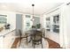 Charming dining area with a modern light fixture, large windows, and a round table with four chairs at 5630 Winthrop Ave, Indianapolis, IN 46220