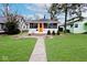 Charming single-story home with an orange front door and a well-maintained front yard at 5630 Winthrop Ave, Indianapolis, IN 46220