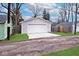 Detached garage with white door and new concrete driveway at 5630 Winthrop Ave, Indianapolis, IN 46220