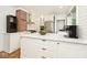 Modern kitchen with white cabinets, stainless steel appliances, and a large island with seating at 5630 Winthrop Ave, Indianapolis, IN 46220