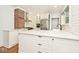 Bright kitchen features an island, stainless steel appliances, brick accent wall and white cabinetry at 5630 Winthrop Ave, Indianapolis, IN 46220