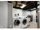 Basement laundry area with side by side washer/dryer and utility sink at 5630 Winthrop Ave, Indianapolis, IN 46220
