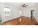 Sunlit living room with large windows, hardwood floors, and a ceiling fan at 5630 Winthrop Ave, Indianapolis, IN 46220