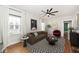 Comfortable living room with a tufted sofa, patterned rug, and lots of natural light at 5630 Winthrop Ave, Indianapolis, IN 46220