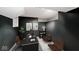 Modern office featuring a long desk with chairs, black walls, and neutral flooring at 5630 Winthrop Ave, Indianapolis, IN 46220
