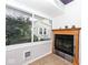 Cozy sunroom boasts a fireplace, natural light, and a seamless blend of indoor and outdoor living at 5630 Winthrop Ave, Indianapolis, IN 46220