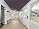 Bright sunroom features tile flooring, neutral walls, and a connection to the outdoors at 5630 Winthrop Ave, Indianapolis, IN 46220
