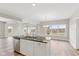 Modern kitchen with island, white cabinets, and granite countertops at 6207 Preserve Way, McCordsville, IN 46055