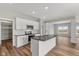Modern kitchen with white cabinets, granite countertops, and stainless steel appliances at 6207 Preserve Way, McCordsville, IN 46055