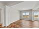 Bright and airy living area with hardwood floors and built-in shelving at 6207 Preserve Way, McCordsville, IN 46055