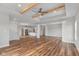 Open concept living room and kitchen with hardwood floors and exposed beams at 6207 Preserve Way, McCordsville, IN 46055