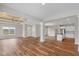 Open concept living room with hardwood floors, kitchen island and exposed beams at 6207 Preserve Way, McCordsville, IN 46055
