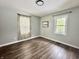 Bright bedroom with wood-look floors and a window offering natural light at 6220 Dean Rd, Indianapolis, IN 46220
