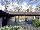 Charming home features a gray exterior, black trim, and well-maintained landscaping at 6220 Dean Rd, Indianapolis, IN 46220