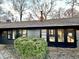 This charming home features a grey exterior, black trim, and lush greenery at 6220 Dean Rd, Indianapolis, IN 46220