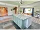 Kitchen island with stone countertops, custom cabinetry, and an open design that flows into the living area at 6220 Dean Rd, Indianapolis, IN 46220