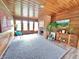 Spacious living room showcasing wood paneled walls, a charming fireplace, and ample natural light for entertaining at 6220 Dean Rd, Indianapolis, IN 46220