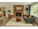 Inviting living room featuring a cozy fireplace, comfortable seating, and a large window for natural light at 6220 Dean Rd, Indianapolis, IN 46220