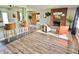 Spacious open-concept living area with wood floors, brick fireplace, stylish seating, and easy access to kitchen at 6220 Dean Rd, Indianapolis, IN 46220