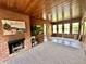 Cozy living room featuring a rustic fireplace, wood-paneled walls, and a relaxing atmosphere for gathering at 6220 Dean Rd, Indianapolis, IN 46220