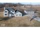 Aerial view of a two-story home with an attached and detached garage on a rural lot at 9222 W State Road 38, Lapel, IN 46051