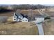 Aerial view of a two-story home with an attached and detached garage on a rural lot at 9222 W State Road 38, Lapel, IN 46051