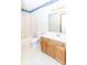 Bathroom with white walls and toilet, with a double vanity with light wood cabinets at 9222 W State Road 38, Lapel, IN 46051