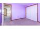 This bedroom features purple walls, carpeting, wood trim and a closet with sliding doors at 9222 W State Road 38, Lapel, IN 46051