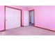 This bedroom features pink walls, carpeting, and a closet with sliding doors at 9222 W State Road 38, Lapel, IN 46051