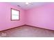 This bedroom features pink walls, carpeting, wood trim around the window and baseboard at 9222 W State Road 38, Lapel, IN 46051