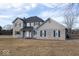 A two-story home is featured with gray siding, blue shutters, and a well-kept lawn at 9222 W State Road 38, Lapel, IN 46051