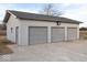 Exterior view of the garage, which has three garage doors and a side door at 9222 W State Road 38, Lapel, IN 46051